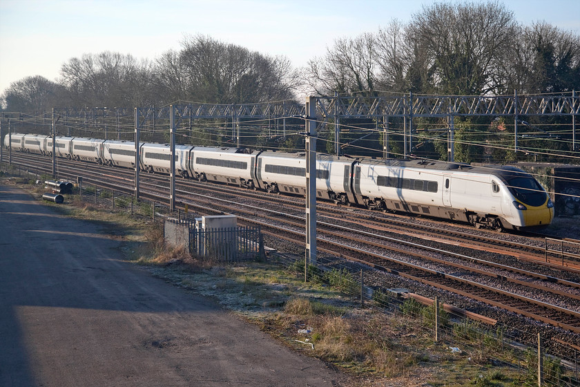 390008, VT 06.43 London Euston-Wolverhampton (9G01, 1E), site of Roade station 
 The bright and shiny side of 390008 'Charles Rennie Mackintosh' catches the early morning sunshine as it passes the site of Roade station. The Pendolino is working the 9G01 06.43 Euston to Wolverhampton service. Notice the frost still on the grass in the shade of the fences and houses to the left. 
 Keywords: 390008 06.43 London Euston-Wolverhampton 9G01 site of Roade station Avanti West Coast Pendolino Charles Rennie Mackintosh