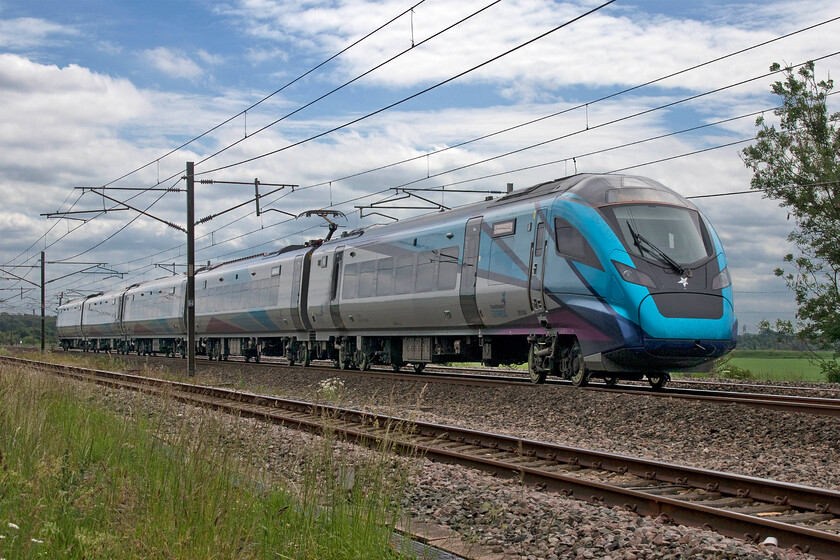 397004, TP 12.12 Edinburgh Waverley-Manchester Airport (1M97 RT), Mossband M6 bridge NY347654 
 A 'going away' photograph of TransPennine Express' 397004 heads south past Mosband on the Scottish border working the 1M97 12.12 Edinburgh to Manchester Airport service. Andy and I really liked our all too brief stop at this location with its open views of the northern WCML and wished that we could have stayed a little longer and that we had been able to capture a freight working. However, we had the prospect of a long drive south back home to Northamptonshire ahead so decided that we should soon be pushing on. 
 Keywords: 397004 12.12 Edinburgh Waverley-Manchester Airport 1M97 Mossband M6 bridge NY347654 TPE TransPennine Express Nova 2