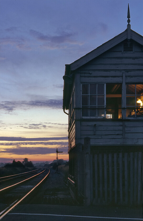 Codford signal box (GW, date unknown) 
 Looking northwest towards Warminster Codford signal box is seen very much in the twilight of its operating life similar to the time of the day when it is being photographed! It had just ten months left in operation before closure was to take place with an automatic half-barrier crossing being installed and colour lights coming under the control of the Salisbury panel. There was once a station at Codford that closed, along with all the others in the Wylye valley between Warminster and Salisbury, on 19.09.55. 
 Keywords: Codford signal box GWR Great Western Railway