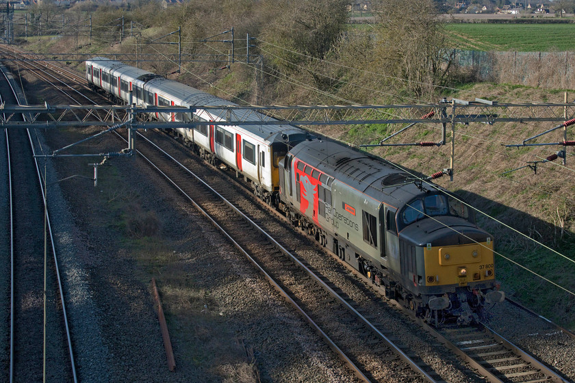 37800 & 317344, 08.28 Kilmarnock Bonnyton Depot-Wolverton Centre Sidings (5Q50, 16E), Victoria bridge 
 I had been tracking this all day on RTT with great anticipation! Then, in the last half hour before its passing, my mobile 'phone crashed and would not restart so I just had to go back to the old way of waiting and hoping! This also thwarted my hope to record this Class 37 passing. Owned by Europhoenix but leased and operated by Rail Operations Group (ROG) 37800 'Cassiopeia' drags former Greater Anglia 317344 from Kilmarnock to Wolverton as the 5Q50 with the train seen passing Victoria bridge just a short distance from its destination. 
 Keywords: 37800 317344 08.28 Kilmarnock Bonnyton Depot-Wolverton Centre Sidings 5Q50 Victoria bridge ROG Rail Operation Group Cassiopeia