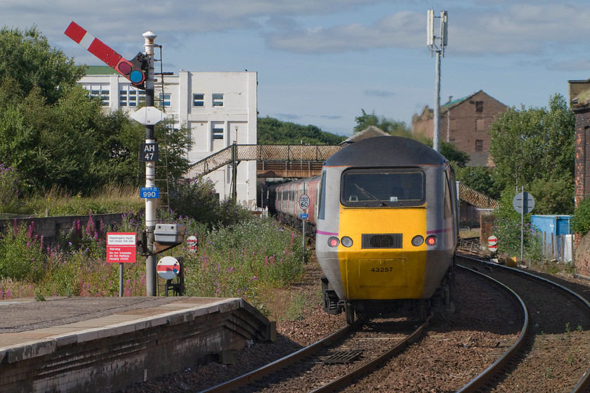 43257, GR 10.00 London King`s Cross-Aberdeen (1S11), Arbroath station 
 The 10.00 King's Cross to Aberdeen HST service gets way from Arbroath station with power car 43257 bringing up the rear of the train. The train has just passed Arbroath's down starter signal AH47. Notice the five disc signals two of which are in amongst the undergrowth to the far left of the image. 
 Keywords: 43257 10.00 London King`s Cross-Aberdeen 1S11 Arbroath station Virgin East Coast HST