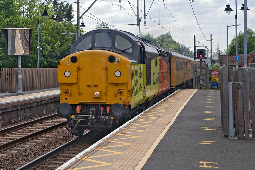 37057, 10.14 Welwyn Garden City-Cambridge Reception Sidings (1Q18, 4E), Ingatestone station 
 37057 makes a heck of a racket as it passes at speed through Ingatestone station on the GEML. It is leading the 1Q18 10.14 Welwyn Garden City to Cambridge test train. Out of sight at the rear was 37254 'Cardiff Canton'. Notice Ingatestone signal box to the right of the colour light that is now demoted to a crossing box with a mini panel installed. I photographed the box in my previous visit to this Essex town back in the summer of 2017, see..... https://www.ontheupfast.com/p/21936chg/24686002204/ingatestone-signal-box 
 Keywords: 37057 10.14 Welwyn Garden City-Cambridge Reception Sidings 1Q18 Ingatestone station Colas Rail