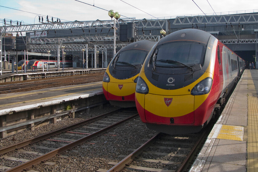 390156, VT 13.17 London Euston-Manchester Piccadilly (1H11), 390128, 10.38 Liverpool Lime Street-London Euston (1A14) & class 390s, London Euston station 
 A lineup of Virgin Pendolinos is seen at Euston station. Over on the far side of the station are a couple of unidentified Class 390s. Meanwhile, nearest the camera is 390156, the first eleven car Pendolino to be released into traffic just over two years ago. My wife and I took this as the 13.17 Euston to Manchester the relatively short distance to Milton Keynes. Tucked in behind the nearest Pendolino is 390128 'City of Preston' that has recently terminated as the 10.38 ex Liverpool Lime Street. 
 Keywords: 390156 13.17 London Euston-Manchester Piccadilly 1H11 390128 10.38 Liverpool Lime Street-London Euston 1A14 class 390s London Euston station Virgin West Coast Pendolino City of Preston