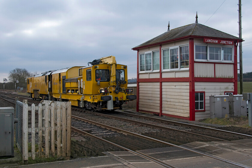 DR80209, 10.32 Bedford Engineers Sidings-Peterborough Tamper Sidings (6U29, 7E), Langham Junction level crossing 
 Class YZA-Stoneblower DR80209 has just emerged from the loop at Langham Junction having been held for the passage of a CrossCountry unit and is about to pass the lovely 1890 Midland signal box. Working the 10.32 Bedford Engineers Sidings to Peterborough Tamper Sidings move. The stoneblower will soon cross over and work back past this spot heading east towards its destination. Interestingly, we were also to go into the up loop here at Langham tomorrow afternoon on the Verney Venturer charter but it was to be in the dark on a dismal Saturday evening! 
 Keywords: DR80209 10.32 Bedford Engineers Sidings-Peterborough Tamper Sidings 6U29 Langham Junction level crossing stoneblower Midland Railway