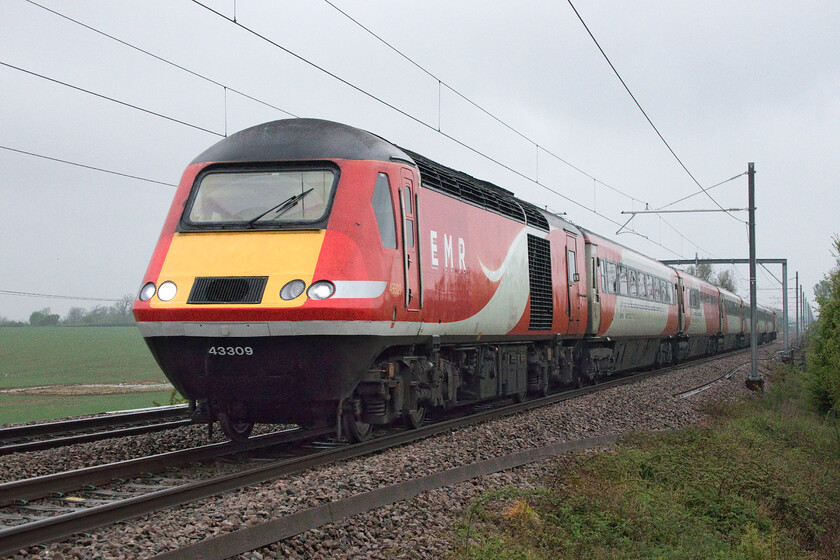 43309, EM 05.19 Leeds-London St. Pancras (1C15, 1E), Wymington SP956634 
 On the penultimate day of HST operations on the Midland Main Line, the 05.19 Leeds to St. Pancras 1C15 service works hard as it ascends towards Sharnbrook summit past the village of Wymington in Bedfordshire. With a blow of the horn from the waving driver as it passes, 43309 leads the train. I have photographed this power car many times, in happier days, for example...... https://www.ontheupfast.com/p/21936chg/25778360204/x43309-14-52-aberdeen-london-king 
 Keywords: 43309 05.19 Leeds-London St. Pancras 1C15 Wymington SP956634 EMR East Midlands Railway HST