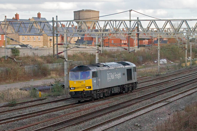 60029, 15.52 (!) Willesden DCR Sidings-Leicester LIP (0Z61, 8L), site of Roade station 
 With DCR now the only operator of Class 60s the chance to photograph one is worth the effort. Running as 0Z61 the 15.52 from Willesden to Leicester passes the site of Roade's former station. Quite why it was timetabled to leave at half a minute after eight minutes to four is extremely odd and bizarrely precise! 
 Keywords: 60029 15.52 Willesden DCR Sidings-Leicester LIP 0Z61 site of Roade station