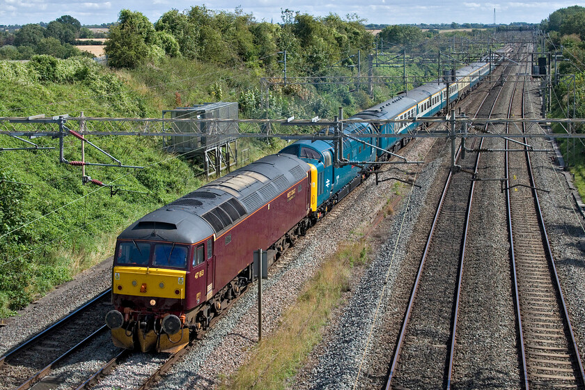 47813 & 55009 (55013), 13.25 Acton Lane Reception Sidings-Burton Ot Wetmore (5Z58, 2E), Victoria bridge 
 47813 leads a dead 55009 'Alycidon' doing its best to be 55013 'The Black Watch' past Victoria bridge just south of Roade. Gathered enthusiasts were hoping that the Deltic would have been leading the 13.25 Acton Lane Reception Sidings to Burton Ot Wetmore empty stock working but due to the failure (but with a subsequent restart) of 55009 at Retford the previous evening it was not to be. 
 Keywords: 47813 55009 55013 13.25 Acton Lane Reception Sidings-Burton Ot Wetmore 5Z58 Victoria bridge The Black Watch Alycidon