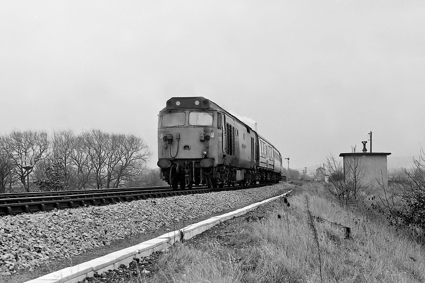 50004, 10.30 London Paddington-Paignton (1B35), Heywood Road 
 50004 'St. Vincent' slows for its stop at Westbury station having come off the mainline at Heywood Road Junction, the signal box that sits at the junction can be seen in the background to the left of the linesman's hut. Just above the roof of the class 50 is the chimney of the now closed Westbury cement works. 
 Keywords: 50004 10.30 London Paddington-Paignton 1B35 Heywood Road