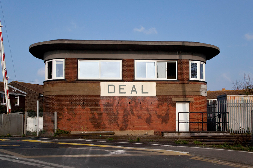 Deal Signal Box (SR, 1939) 
 There is no doubting your location given the size if it nameplate! Deal signal box is a Southern Type 13 box opened in 1939. Locally it's referred to as 'the Glasshouse' but more usually it's referred to as being of the 'art-deco' or 'odeon' style. However you refer to it, it's an impressive structure that still controls semaphores within the environs of the station that is a short distance to the right of this picture. With the sun refelcting off the large windows the camera stuggled to get a proper exposure but this passable picture results. 
 Keywords: Deal Signal Box