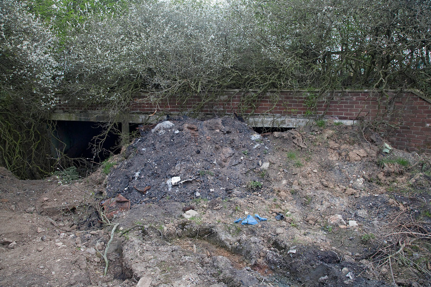 Former visitor tunnel, Filey Holiday Camp station 
 This was an eerie spot! The tunnels that ran under the A165 road are still extant if virtually filled in and full of water. These short tunnels allowed the holidaymakers, who arrived and departed from Filey Holiday Camp station, just behind me, to safely access the camp complex without crossing the main road above. They were taken through the tunnels in motorised led trains of brightly covered cars with their baggage following behind on flat-bed cars rather like those seen at airports today. This is all that remains of the holiday camp complex now as it was flattened in various stages between 1988 and 2003 and has now been built on to become the inevitable housing estate. A reminder of a different time in our social history when these 'Hi-de-Hi' styles of holidays were so popular. 
 Keywords: Former visitor tunnel Filey Holiday Camp station