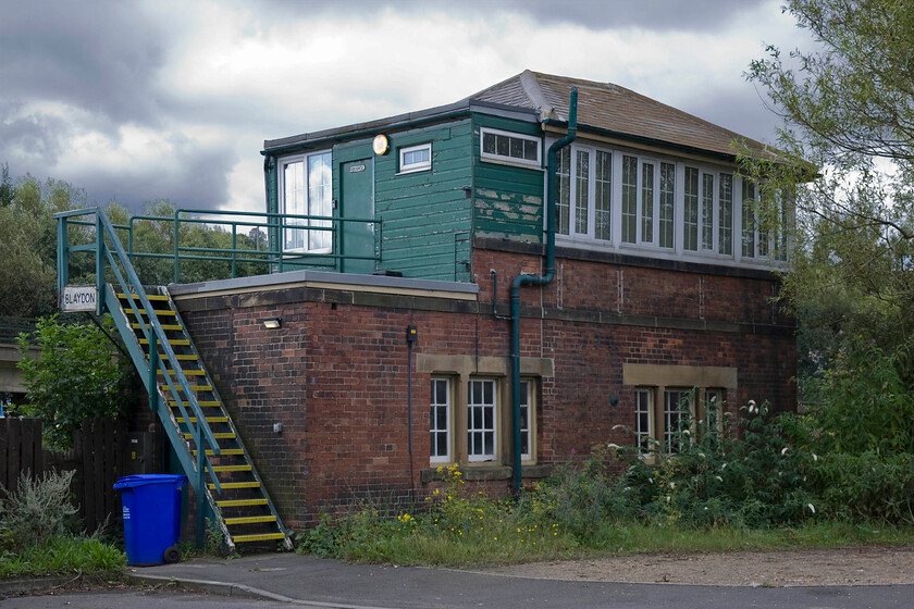 Blaydon signal box (NE, not known) 
 There is a number of contemporary photographs on the internet showing this side of Blaydon signal box when it actually faced railway tracks rather than trees! This was the front of the box with the former direct route into Newcastle Central via the Scotswood bridge and the north bank of the Tyne passing directly where I am standing. This line was shut by BR in 1982 with all traffic diverted via the rather long-winded route along the south bank of the Tyne via the newly opened Metro Centre station. All of the building this side of the hip end in view here is new and does nothing for the aesthetics of the otherwise classic NER design. 
 Keywords: Blaydon signal box North Eastern Railway