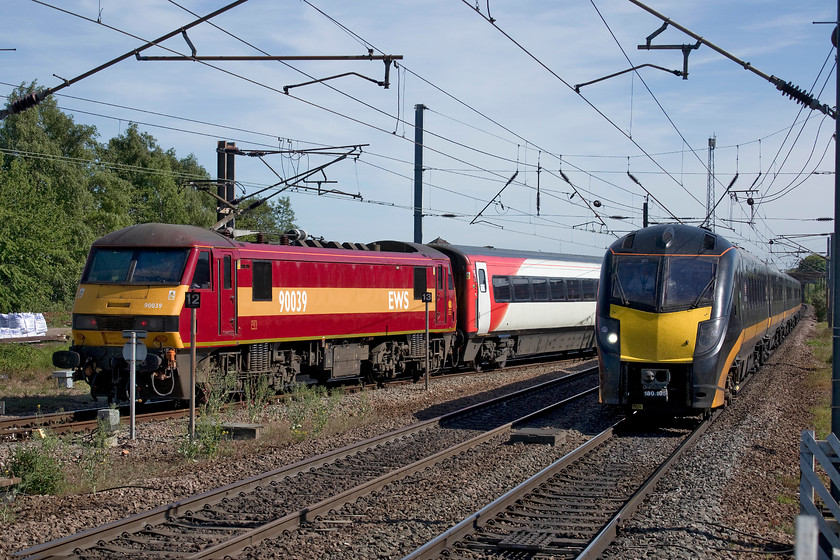 90039, GR 15.56 Newark Northgate-London King`s Cross (1B87, 2L) & 180109, GC 14.48 London King`s Cross-Bradford Interchange (1D73, RT), Newark Northgate station 
 This photograph was a close call! Mike and I waited at the southern end of platform one at Newark Northgate to witness the departure of the 15.56 to King's Cross in order to get a picture of 90039 pushing the train at the rear crossing back on to the up fast line. Whilst waiting, I commented to Mike about how ironic it would be if a down service was to pass and spoil the event, and it very nearly did! Grand Central's 180109 works the 14.48 King's Cross to Bradford Interchange at full line speed northwards approaching the station about to block the southbound service. Apart from the class 90 being a little obscured by signage, I wanted it a little further away, it just about worked with split-second timing! 
 Keywords: 90039, GR 15.56 Newark Northgate-London King`s Cross (1B87, 2L) & 180109, GC 14.48 London King`s Cross-Bradford Interchange (1D73, RT), Newark Northgate station