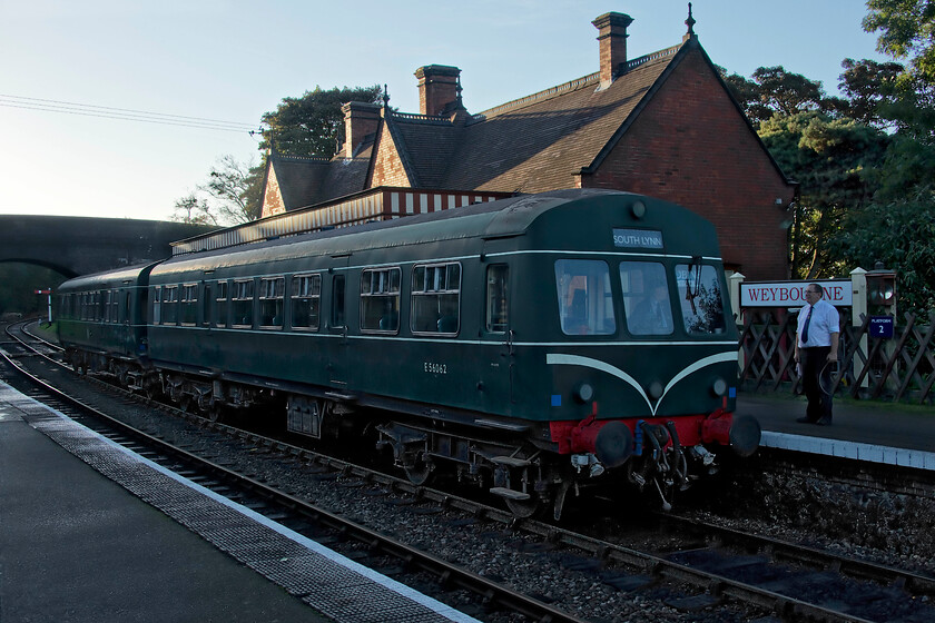 E51188 & E56062, 16.35 Holt-Sheringham, Weybourne station 
 With all but the roof of Weybourne's station now in deep shadow as the sun lowers in the late afternoon sky the final service train of the day pauses at the platform. The signalman chats to the driver of the 16.35 Holt to Sheringham, being worked by E51188 and E56062, prior to its departure. Following its arrival at Sheringham, the unit will return as empty stock to enter Weybourne's yard for overnight servicing. However, by then I will be back in our rented caravan on Kelling Heath enjoying a cup of tea and a crumpet! 
 Keywords: E51188 E56062 16.35 Holt-Sheringham Weybourne station Class 101 DMU