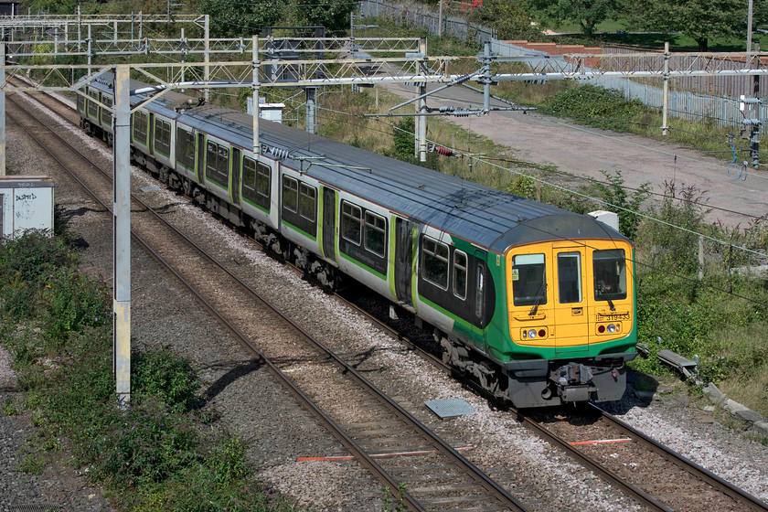 319433, LM 12.38 Northampton TMD-Watford Junction ECS (5F23, 14L), site of Roade station 
 I very rarely see the London Northwestern operated Class 319 units actually operating service trains. Nearly all of my photographs of them are working empty stock moves including this one, the 12.38 Northampton Kingsheath depot to Watford Junction. 319433 is seen passing the site of Roade station. 
 Keywords: 319433 12.38 Northampton TMD-Watford Junction ECS 5F23 site of Roade station