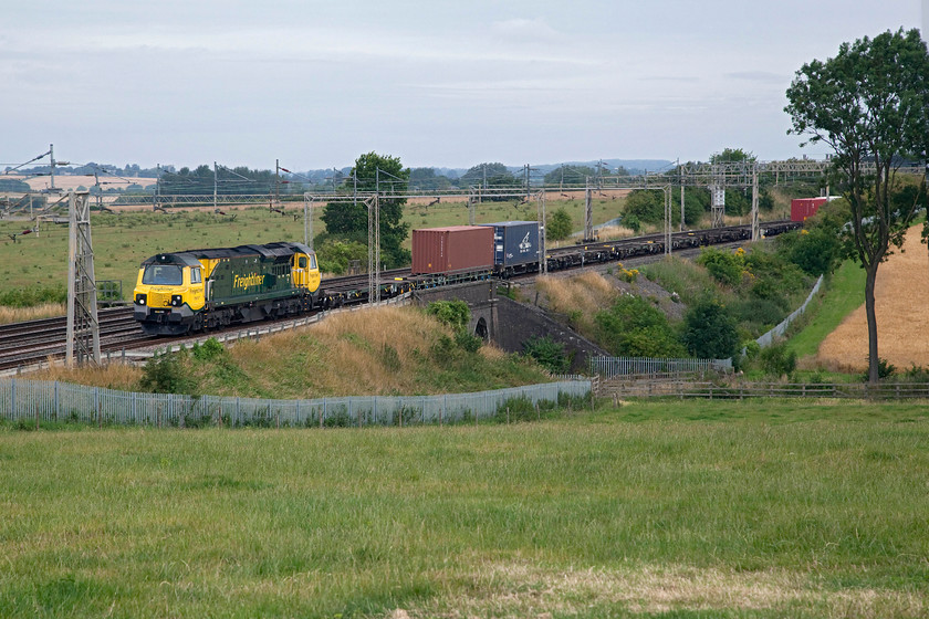 70017, 03.35 Garston-London Gateway (4L52), Castlethorpe SP795447 
 70017 shatters the peace of the North Buckinghamshire countryside leading the 03.35 Garston to London Gateway 4L52 Freightliner. It is seen crossing Three Arches bridge just north of the village of Castlethorpe. 
 Keywords: 70017 03.35 Garston-London Gateway 4L52 Castlethorpe SP795447