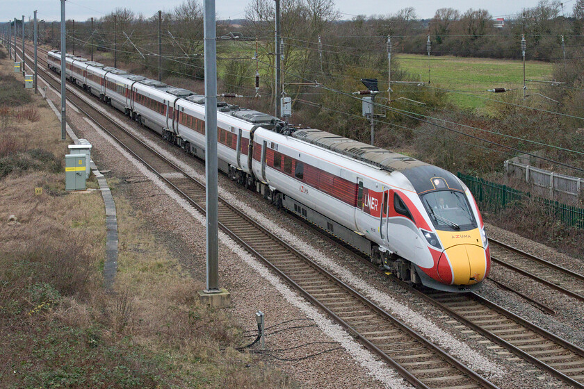 801207, GR 06.56 Edinburgh Waverley-London King's Cross (1E04, 24L), Marholm TF154036 
 The 06.56 Edinburgh Waverley to King's Cross approaches Marholm just north of Peterborough worked by Azuma 801207. Notice buried in the grass to the left adjacent to the electrical boxes the eighty-miles post indicating the distance from King's Cross. Just by way of comparison, the same distance on the other main arterial routes from London are as follows:-

GEML - Stowmarket
MML - Market Harborough
WCML - Hillmorton Junction (Rugby)
Chiltern Mainline - Hatton (Warwickshire)
GWML - Just west of Swindon
SWML - Millbrook (Southampton)
North Kent line (as the SEML does not quite extend that far with Dover at seventy-seven miles!) - Ramsgate 
 Keywords: 801207 06.56 Edinburgh Waverley-London King's Cross 1E04 Marholm TF154036 LNER Azuma