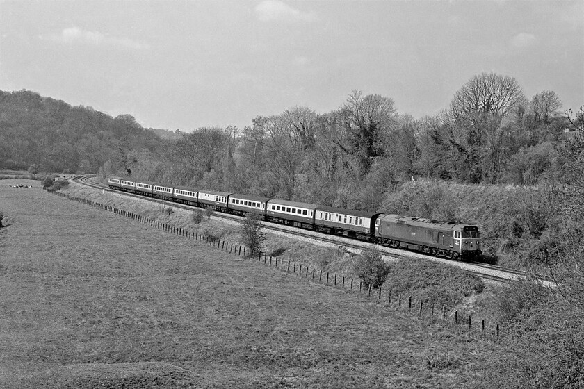 Class 50, unidentified up diverted working, Avoncliff aqueduct 
 Taken from the southern end of Avoncliff's aqueduct that carries the Kennet and Avon canal from one side of the valley to the other a Class 50 is seen. It is leading an unidentified up diversion composed of a rake of Mk. II stock with a Mk. I buffet/restaurant coach and the ubiquitous Mk. I BG marshalled behind the locomotive. Notice the heard of Friesian cattle at the far end of the field that all appear to be sitting down perhaps indicating that rain is on its way? 
 Keywords: Class 50 unidentified up diverted working Avoncliff aqueduct