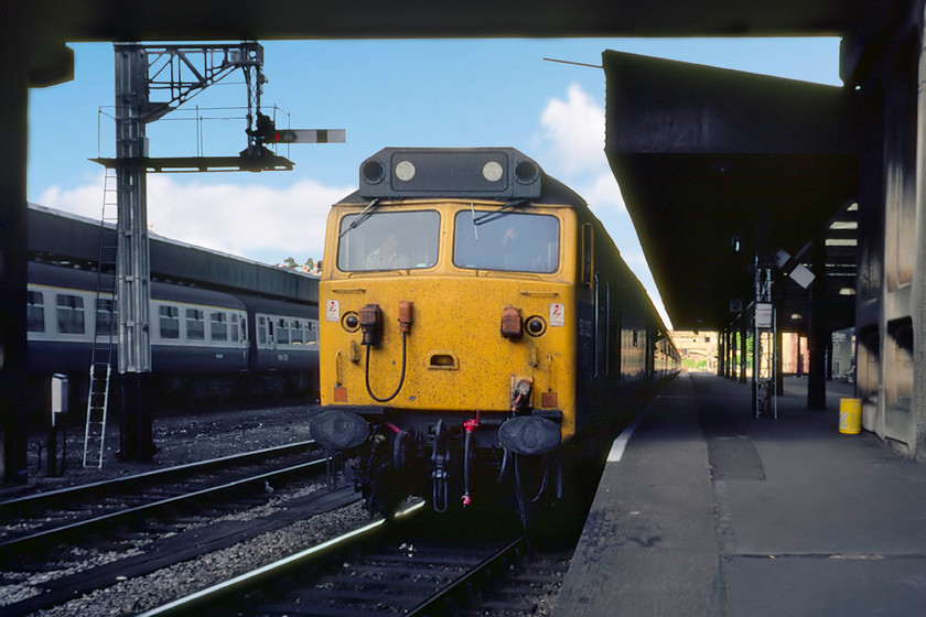 50025, 15.10 London Waterloo-Exeter St. David's, Exeter Central station 
 With a cheery wave (or is it a gesticulation warning me to get off the platform ramp) from the driver of 50025 'Invincible' as he is about to get the 15.10 Waterloo to Exeter St. David's away from Exeter Central station. Notice the mixture of semaphore arm types in this view. The Great Western lower quadrant platform starter is pulled off whereas the centre road's home is a longer Southern Region upper quadrant - this is what happens when west meets south! 50025 was a relatively early withdrawal in August 1989 coming to an ignominious end after being derailed at West Ealing after hitting some waste track that had been placed on the railway by vandals. Thankfully there were no major injuries or deaths. 
 Keywords: 50025, 15.10 London Waterloo-Exeter St. David's, Exeter Central station Invincible