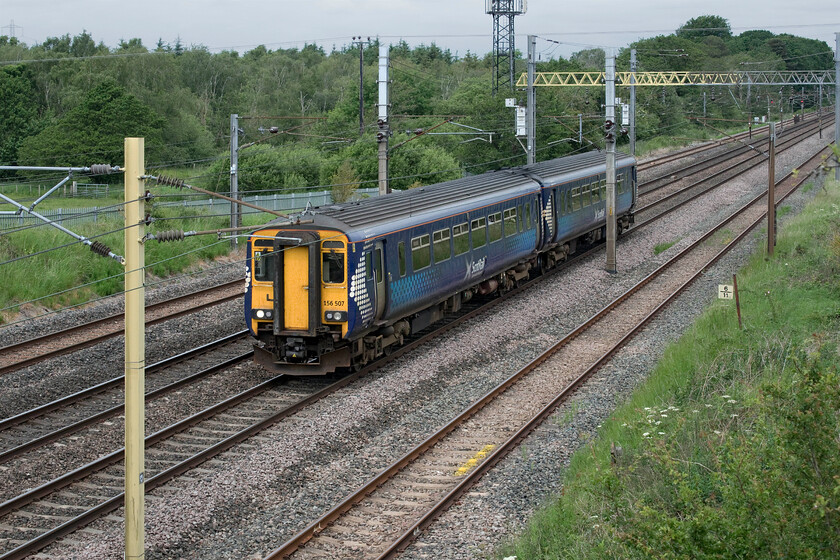 156507, SR 10.13 Glasgow Central-Carlisle (1L53, 1L), Blackrigg bridge NY364624 
 Blackrigg bridge is located six and a half miles north (according to the milepost) of Carlisle a short distance away from the enormous Kingmoor Yard near the village of Rockcliffe. It affords reasonable views of the WCML that are more favourable looking north as seen here. ScotRail's 156507 works the 1L53 10.13 Glasgow to Carlisle 'local' that has travelled the Glasgow and South Western Railway route via Kilmarnock and Dumfries. 
 Keywords: 156507 10.13 Glasgow Central-Carlisle 1L53 Blackrigg bridge NY364624 ScotRail