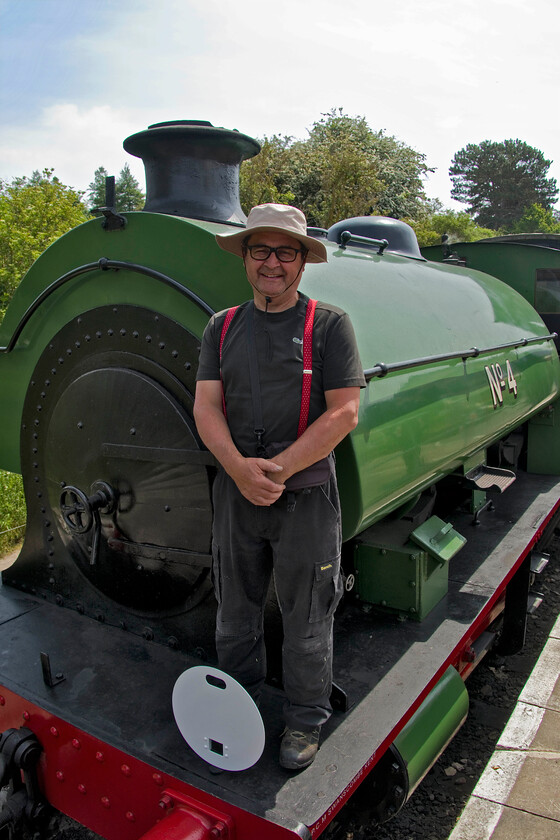 Me on, No. 4, 12.00 Pitsford return 
 The Northampton and Lamport Railway's Peckett now numbered 4 (previously 2104) is seen at Pitsford station with yours truly standing on the buffer beam. I had an interesting run on the footplate of the Peckett with the driver and fireman even if it was a little cramped! 
 Keywords: No. 4, 12.00 Pitsford return