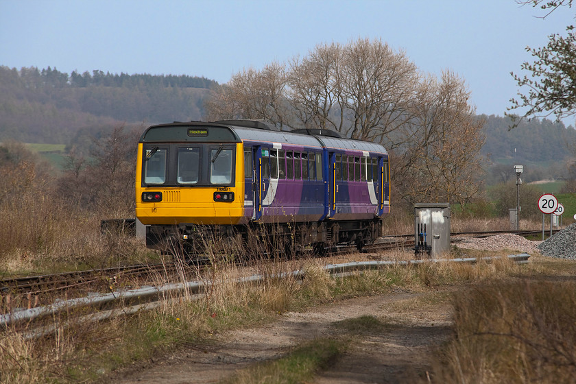 142071, NT 11.58 Whitby-Hexham (2W35, 3L), Battersby 
 142071 has left Battersby station and is now continuing its journey from Whitby on towards Middlesborough and, ultimately, Hexham in the Tyne valley. The Pacer will soon take a sharp turn to the left past the colour light at the 20mph speed restriction and head down hill to its next stop at Great Ayton. This picture is taken using my lovely Sigma 80-200 zoom, a lens that I don't use as often as I should do. 
 Keywords: 142071 11.58 Whitby-Hexham 2W35 Battersby