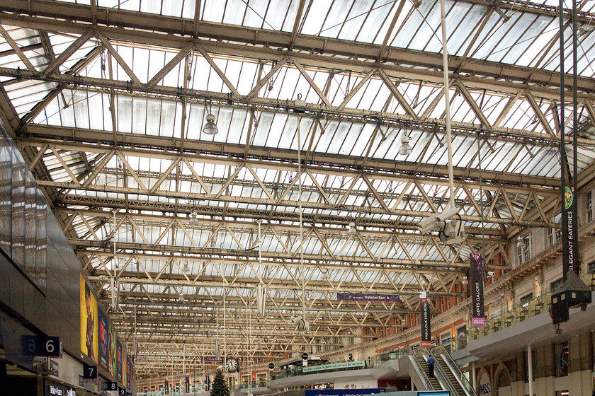 Roof, London Waterloo station 
 Apart from to look up at the clock, I wonder how many people raise their heads to look at Waterloo's roof? It's an impressive structure that lets in a huge amount of natural light on to the concourse, unlike many modern stations. Also note, the mezzanine level that was completed at huge expense in 2012. 
 Keywords: Roof London Waterloo station