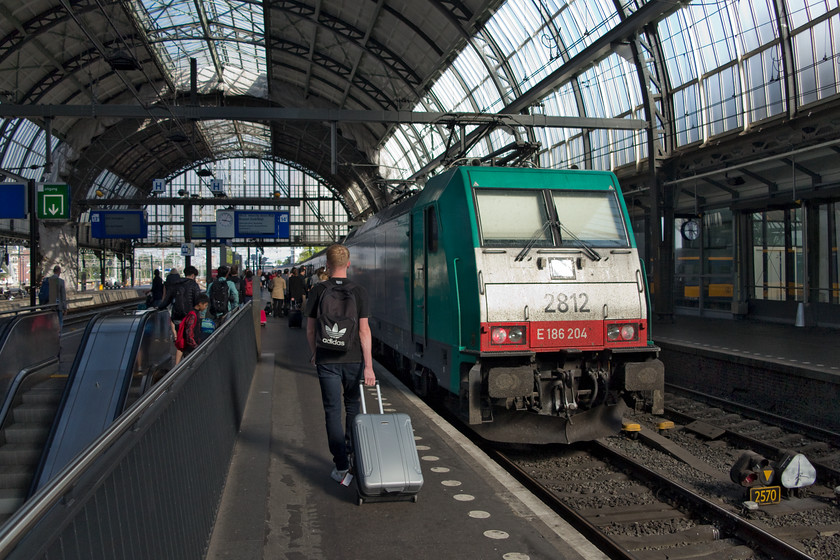 186 204, 09.22 Amsterdam Central-Brussels Mid (IC 9224), Amsterdam Central station 
 My son strikes a pose walking along platform 14 at Amsterdam Central station to catch the 09.22 to Brussels Midi. We took this train as far as Schiphol Airport in order to take our flight home. This train was worked in top and tail mode with 186 204 seen here on the rear and 186 297 on the front. 
 Keywords: 186 204 09.22 Amsterdam Central-Brussels Mid IC 9224 Amsterdam Central station