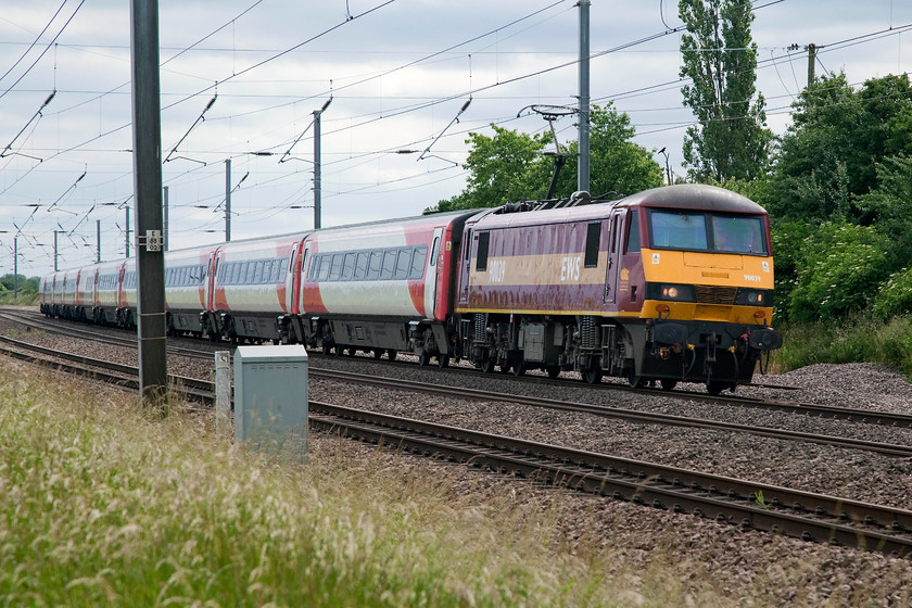 90039, GR 15.03 London King`s Cross-Leeds (1D19, 13L), Offord D`Arcy TL213652 
 Due to problems with class 91 availability Virgin East Coast (The following weekend to become state owned again as LNER) have had to draft in a 'proper' locomotive to haul some of their Mk.IV sets. Here, 90039, hired in from DB Cargo UK (formally EWS), hauls the 15.03 London King's Cross to Leeds 1D19 working. It is seen passing near to Offord D'Arcy taking the second of a series of reverse curves that follow the course of the nearby River Great Ouse. 
 Keywords: 90039 1D19 Offord DArcy TL213652