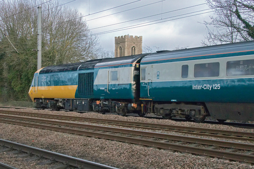 43006, final leg of Let`s go Round Again, 11.01 Leeds-London King`s-Cross (1Z43), Gill`s Crossing 
 A photograph that could have been taken in the 1970s or 1980s (apart from the electrification equipment and it being on the ECML as opposed to the GWML) shows the early Western Region HST power car W43003 passing Offord Cluny. W43003 (ex of 253003) is seen, along with an InterCity 125 liveried coach, at the rear of the final leg of the Let's go Round Again charity railtour to bring the curtain down on ECML HST operations. Unfortunately, control had deemed it appropriate to put the train on the up slow from Huntingdon into King's Cross so there was little fast running on this final run. I was very surprised to be joined by about ten people at this spot meaning it was a little cramped and that prevented me from getting a 'going-away' photograph. A number of us commented on how bizarre it was that here were all gathered to witness this event over forty years after the introduction of the HSTs when we resented their arrival. After the train had passed, a fellow enthusiast cheerily walked away saying 'see you all in twenty years' time for the Azuma farewell!' 
 Keywords: 43006 Let`s go Round Again 11.01 Leeds-London King`s-Cross 1Z43 Gill`s Crossing HST farewell InterCity 125 Offord Cluny 253003 43206