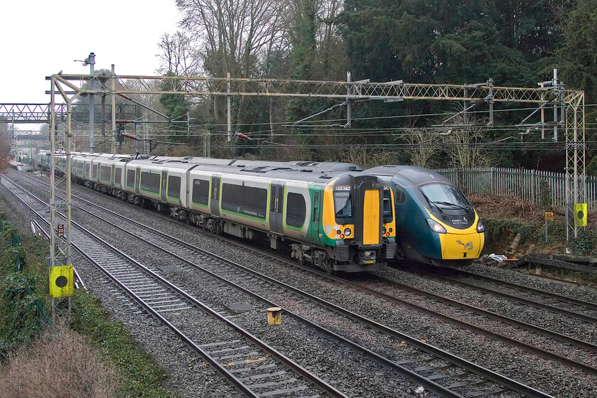 350242, LN 07.36 Birmingham New Street-London Euston (1Y20, 11L) & 390127, VT 09.16 London Euston-Glasgow Central (9S55, RT), Apsley 
 Just north of Apsley station is a small overbridge that carries a footpath leading across towards Shendish Manor golf course. Whilst a little confined by trees, the footbridge offers some reasonable photographic opportunities. The 07.36 Birmingham to Euston London MIdland service, worked by 350242 at the rear, passes 390127 working the 09.16 Euston to Glasgow Avanti service. Whilst the Desrio arrived over ten minutes late the Pendolino was right time into Glasgow. 
 Keywords: 350242 07.36 Birmingham New Street-London Euston 1Y20 390127 09.16 London Euston-Glasgow Central 9S55 Apsley London Northwestern Desiro Avanti West Coast Pendolino