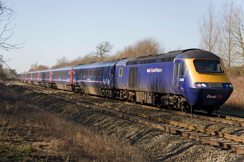 43129, GW 10.30 Bristol Temple Meads-London Paddington (1A13), Knighton crossing SU276890 
 Having walked back to the former level crossing at Knighton, I heard the sound of a distant HST somewhere west of Swindon through the still winter air. 43129 leads the 1A13 10.30 Bristol Temple Meads to Paddington past the site of the level crossing that was closed in the early 1970s with an under bridge replacing it. This road passing under this bridge is often subject to flooding during periods of heavy rain forcing drivers on a long diversion in order to avoid it. 
 Keywords: 43129 10.30 Bristol Temple Meads-London Paddington 1A13 Knighton crossing SU276890