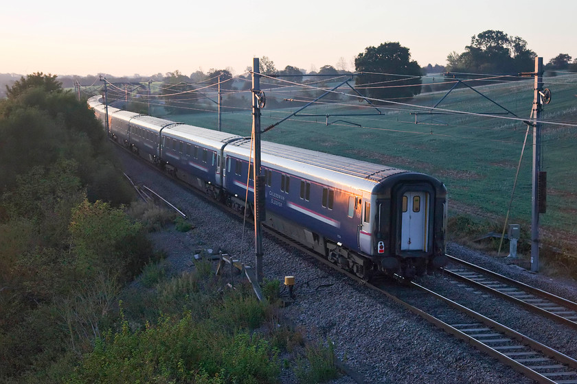 Stock, CS 19.50 Fort William, 21.43 Aberdeen & 20.45 Inverness-London Euston (1M16, 3E), Blisworth 
 Is this the final picture that I will manage of the Mk. III sleeper stock-your guess is as good as mine! The CAF Mk. Vs should have been in use on all of the CS trains for six months now but due to continuing technical issues, this has not been able to happen. Let's hope that CAF and CS can sort out these issues so passengers can get to experience the new and very expensive stock as soon as possible and to restore the operators somewhat tarnished reputation. The 1M16 Highland service is seen passing Blisworth as the sun just raises its head above the horizon on what would be yet another glorious September day. 
 Keywords: Stock 19.50 Fort William 21.43 Aberdeen 20.45 Inverness-London Euston 1M16 Blisworth