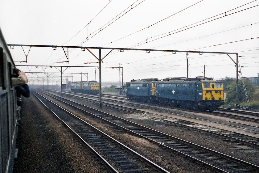 76021, 76038, 76013, 76053 & 76031, stabled, Rotherwood Exchange sidings 
 At the eastern end of the Woodhead route was Rotherwood Exchange sidings where the wires stopped. Here, the 76s were removed from the cross-Pennine freights and diesels attached for onward movement. Rotherwood sidings was situated between Orgreave Lane (of colliery fame) and Retford Road in the district of eastern Sheffield called Woodhouse. The yard is unrecognisable today with most of it covered by the inevitable modern housing estate. In this image, whilst waiting for the 76s to run round the train, 76021, 76038, 76013, 76053 and 76031 are seen stabled waiting for their next job on Monday morning. 
 Keywords: 76021 76038 76013 76053 76031 Rotherwood Exchange sidings