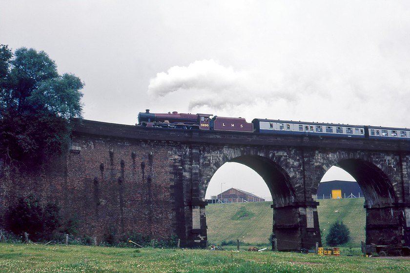 5690, BR sponsored Manchester-Liverpool Edge Hill Special, Sankey viaduct SJ568945 
 With much blowing of its whistle, former LMS Jubilee 5690 (ex BR 45690) crosses Sankey viaduct leading the Manchester to Liverpool Edge Hill BR organised special as part of the Rocket 150 celebrations. When opened, the stonework of the viaduct had a somewhat different appearance than is seen here with the yellow sandstone and red brick having a cleaner and much more yellow colouring. With the pollution of the north-west over the past one hundred and fifty years, it is tarnished and in need of some cleaning especially as it is such a historical structure. Today it is still very much the same with the addition of electrification masts atop the structure and huge volumes of ivy enveloping the piers. Network Rail really could do with undertaking some clearing and cleaning of this fine structure, they would not let a station get into such a state so why this Grade I listed historical structure?

There is an audio recording of this event on my youtube channel, see..https://www.ontheupfast.com/p/21936chg/29578716404/x5690-br-sponsored-manchester-liverpool 
 Keywords: 5690 BR sponsored Manchester-Liverpool Edge Hill Special Sankey viaduct SJ568945 Leander LMS 45690 Jubilee