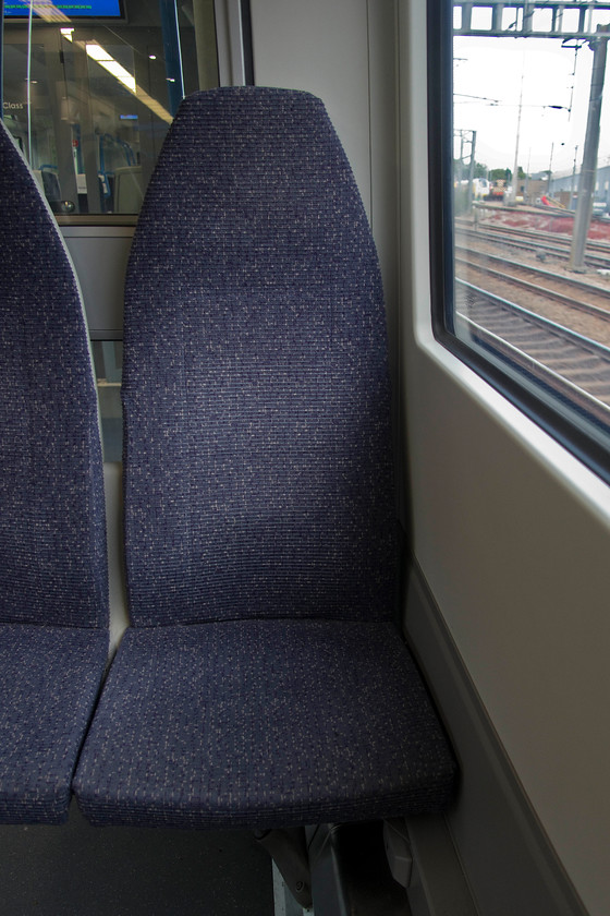 Seat, 700030, GN 12.51 London Kings Cross-Cambridge North (2C26, 6L) 
 Why a picture of a seat in a class 700 you may ask? Why, because it is possibly the most uncomfortable seat on a train that I have sat on! Apart from the backrest being almost vertical from the base meaning that one feels like one is sitting up and begging, it is so hard. I was only on the train for about fifteen minutes as far as Potters Bar but I found myself having to shift from buttock to buttock as they were going numb and I am not kidding! I jest but a serious point here, whilst these are commuter trains where perceived journey times are short, this one goes as far as Cambridge North, a traveling time of over one and a half hours. This would be absolute misery for a passenger doing the whole journey. It's not just these train that are in receipt of complaints about their seating. WHEN are manufactures and operators going to take any notice of what is being said and act upon it? And, absolute piffle to the points raised about them having to be fire retardant to meet H & S legislation, just compare them to the new and deep seats on the Vivarail class 230s. 
 Keywords: Seat 700030 12.51 London King's Cross-Cambridge North 2C26