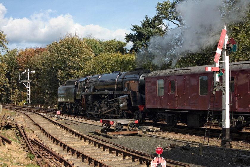 92203, 13.05 Holt-Sheringham, Holt station 
 On our family bike ride to Holt, we stopped off at the NNR station. Whilst we were there, 92203 'Black Prince' is seen leaving with the 13.05 to Sheringham. Notice that the signals are pulled off as they usually are because the box is not normally manned being switched out. The train crew operate the points in order to allow the locos. to run round. 
 Keywords: 92203 13.05 Holt-Sheringham Holt station