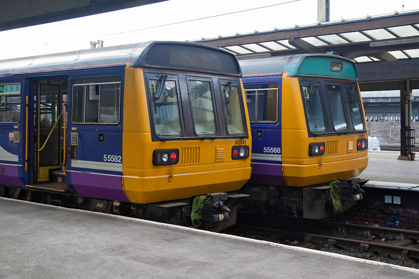 142041 & 142027, stabled, Preston station 
 Double Pacer trouble at Preston! 142041 and 142027 sit in the south-facing bay platforms waiting their next duty. These ageing second generation DMUs have very little time left (at the time of writing) being due for withdrawal. Whilst vilified by many, they have done good service over the thirty years or so that they have been in use, this is actually a fair bit longer than the first generation units that they replaced. 
 Keywords: 142041 142027 Preston station