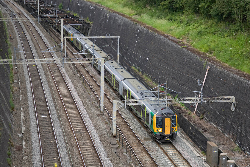 350113 & 350118, LM 11.37 Crewe-London Euston (1U30), Roade cutting 
 350113 leads 350118 out of Roade cutting's fabled 'birdcage' working the 11.37 Crewe to Euston service. The birdcage was installed following the 1890 collapse of the eastern tunnel wall. The cage then created its own issues during the electrification of the line in the early 1960s when it had to be raised. 
 Keywords: 350113 350118 11.37 Crewe-London Euston 1U30 Roade cutting London Midland Desiro