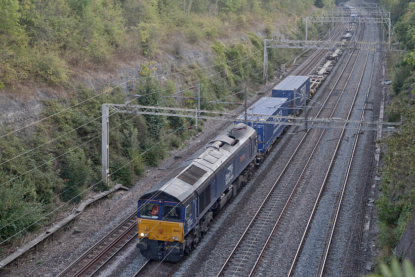 66421, 10.02 Tilbury-DIRFT (4M07, 2E), Roade cutting 
 I have various photographs of DRS' 66421 but none since it was named 'Gresty Bridge TMD' back in 2018 at the Crewe depot's open day of that year. It is seen here passing northwards through Roade cutting with the 10.02 Tilbury to Daventry 4M07 service. 
 Keywords: 66421 10.02 Tilbury-DIRFT 4M07 Roade cutting DRS Direct Rail Services Gresty Bridge TMD