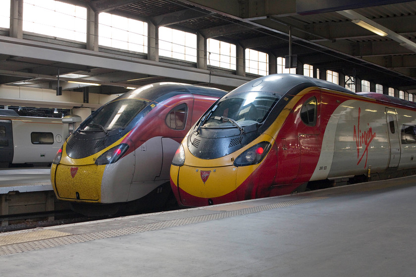 390010, VT 17.43 London Euston-Glasgow (9S97, RT) & 390123, VT 17.33 London Euston-Liverpool (1F23, RT), London Euston station 
 A pair of Pendolinos stand on the stops at London Euston wearing two different Virgin West Coast liveries. On the left is is the first 390 to wear the 'flying silk' livery, 390010 'Cumbrian Spirit' that will work the 9S17 17.43 to Glasgow Central. On the right is 390123 'Virgin Glory' that will form the 17.33 to Liverpool Lime Street. 
 Keywords: 390010 9S97 390123 1F23 London Euston station