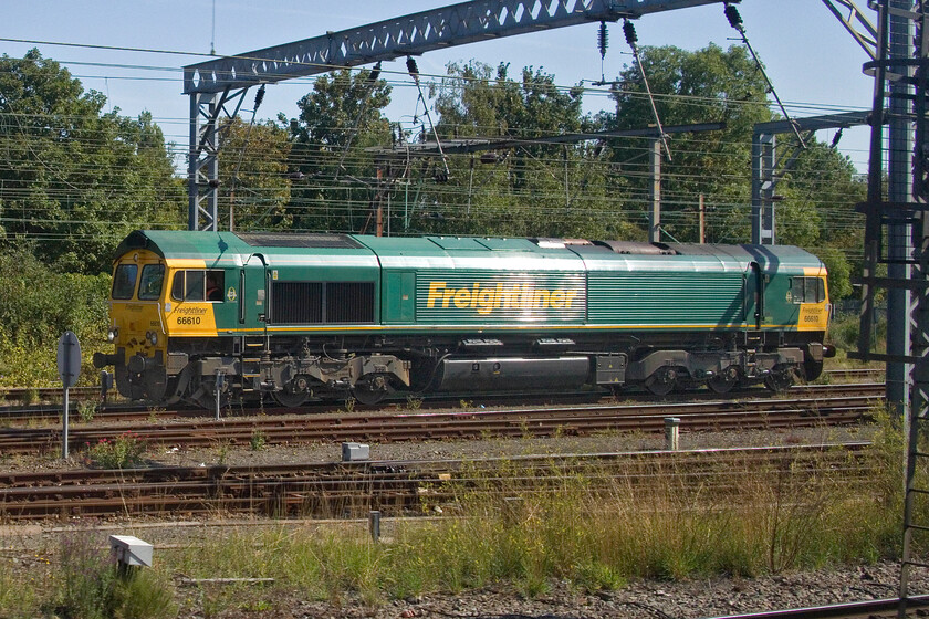 66610, stabled, Wembley Yard 
 Unfortunately, Mike could not access a TOPS report for this day so I could not identify what 66610 was doing in Wembley Yard. It is crewed up and ready for service so unless anybody can advise its next movement will remain a mystery! Notice the exceptional September sunshine glinting on the side of the locomotive. 
 Keywords: 66610 stabled Wembley Yard