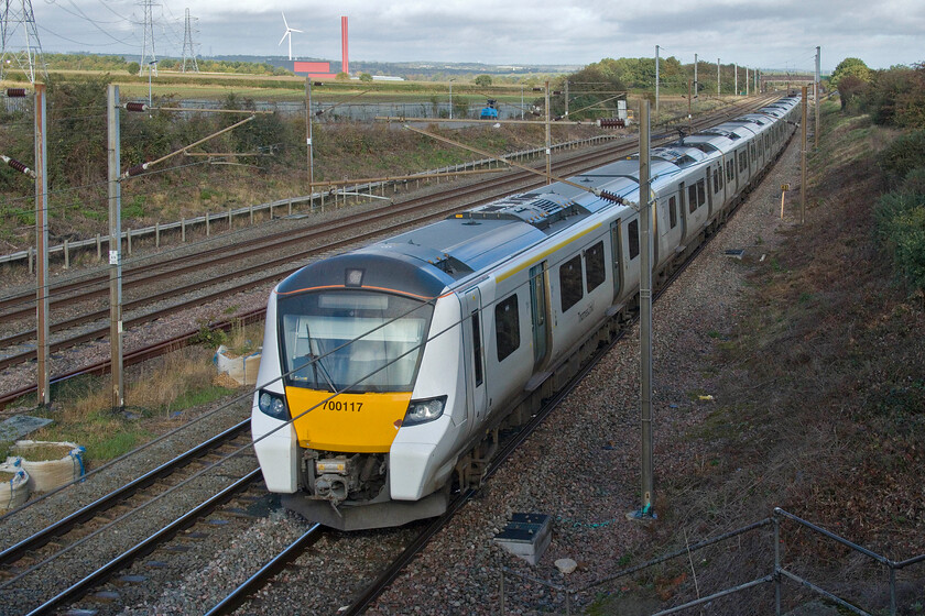 700117, TL 11.04 Bedford-Three Bridges (9R21, RT), Park Road bridge TL020390 
 Thameslink's 700117 heads south past Park Road bridge working the 11.04 Bedford to Three Bridges service soon to enter Ampthill tunnel and then slow for its timetabled stop at Flitwick. The 700s have a total monopoly on Thameslink services on this route and very reliable they have proved to be so far being faster accelerating and twenty-five per cent more efficient than their predecessors*. The unusual building in the background is the recently opened Rookery Pit Energy Recovery Facility (Rookery South) that burns our waste turning it into energy. It can produce up to sixty megawatts from burning five hundred thousand tons of domestic waste per annum.

* Rail Advent 10/07/2021 
 Keywords: 700117 11.04 Bedford-Three Bridges 9R21 Park Road bridge TL020390 Thameslink