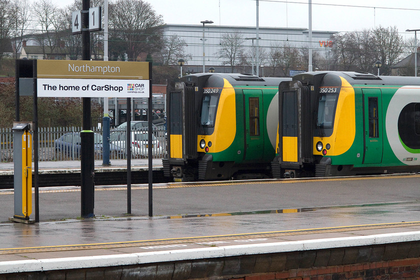 350249 & 350253, stabled, Northampton station 
 At a drab and cold Northampton station, 350249 and 350253 sit stabled in the down facing bay platforms. After years of being used as parcel platforms and then falling out of use, these two platforms were resurrected about ten years ago. 
 Keywords: 350249 350253, stabled, Northampton station