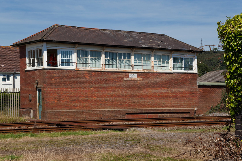 Pembrey signal box (GWR, 1907) 
 Finding Pembrey signal box, despite it being a large GW Type 7 structure that contained an 83 lever frame, proved al little tricky. It is actually situated in the town of Burry Port with the village of Pembrey being about two miles to the east! The box still wears its cast plate, Pembrey East signal box. This location is a significant spot as it marks the end of track circuits and power signalling all the way from Paddington, some 203 miles to the east; from here west it's absolute block all the way! 
 Keywords: Pembrey signal box