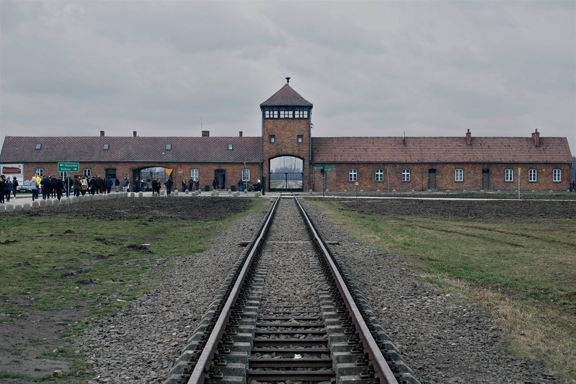 Auschwitz II-Birkenau 
 Looking back to the entrance building and archway of the Auschwitz II-Birkenau death camp creates a chilling image to match the weather. The track outside the entrance is new with concrete sleepers and is now not rail connected according to the most recent Google Earth images of the area. It is staggering to realise that at one point three million people passed through this small and unassuming gateway to be 'processed' by the Nazis. By far the majority were murdered with the rest being put to work to support the war machine of the Third Reich with most only surviving for two months. 
 Keywords: Auschwitz II-Birkenau