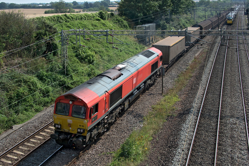 66185, 09.46 Dollands Moor-DIRFT (6M45, RT), Victoria bridge 
 66185 'DP WORLD London Gateway' leads the 09.46 Dollands Moor to DIRFT (Daventry) loaded bottled water train. Unusually, this 6M45 also has some containers in the consist at both the front and the rear. The DB operated Class 66 is also unusual in that it has its nameplates located under the cab windows rather than in the more usual locations on the bodysides. 
 Keywords: 66185 09.46 Dollands Moor-DIRFT 6M45 Victoria bridge DB DP WORLD London Gateway