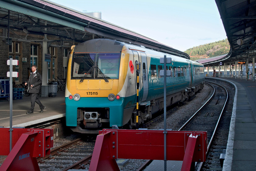 175115, AW 08.31 Manchester Piccadilly-Milford Haven (1V37, 4L), Swansea station 
 We travelled from Cardiff on 175115, still wearing its former ATW livery devoid of branding, as far as Swansea. Here, it stands at platform one ready to retrace its steps as far as Swansea East Loop Junction where it will continue its journey west with the 08.31 Manchester Piccadilly to Milford Haven. Internally, this unit was a little 'tired' and not as comfortable as the class 170 that we had travelled on previously. I hope that the new operator, Transport For Wales, will be doing some work to it when they get around to painting it into their rather bright red livery! Notice the red poppy applied to the font flank, this was taken the week before Remembrance Sunday. 
 Keywords: 175115 08.31 Manchester Piccadilly-Milford Haven 1V37 Swansea station