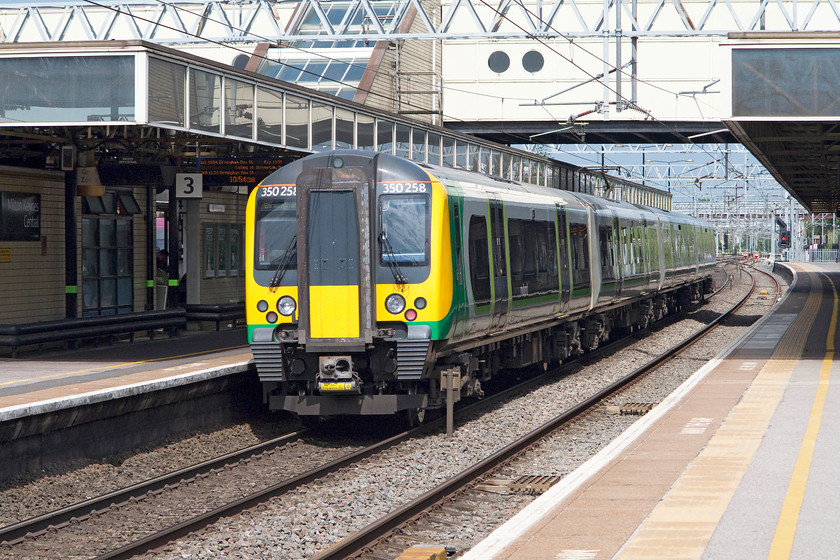 350258, LM 10.13 London Euston-Birmingham New Street (1Y21), Milton Keynes Central station 
 The rear end of London Midland's 350258 sits at Milton Keynes' platform three forming the 10.13 Euston to Birmingham New Street. Despite being built relatively recently in 1982 and having had quite a lot of upgrading, Milton Keynes station is looking a little dated now. This seems to be a bit a problem with cutting edge and modern architectural design, it doesn't age very well; but, hasn't that always been the case? 
 Keywords: 350258 10.13 London Euston-Birmingham New Street 1Y21 Milton Keynes Central station