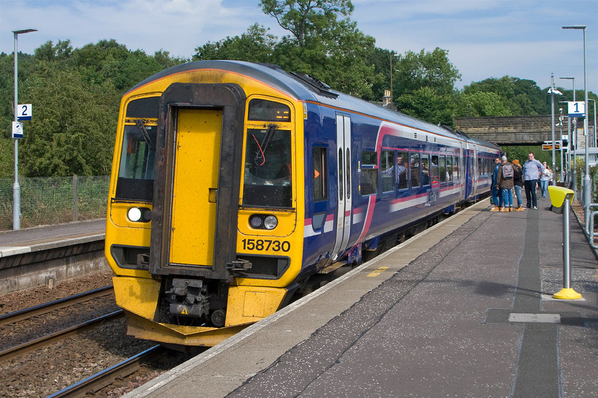 158730, SR 11.28 Dunblane-Edinburgh (2P36), Bridge of Allan station 
 Having seen 158730 undertake a complicated ecs move at Dunblane a little earlier, it is seen now pausing at Bridge of Allen station. The ScotRail unit is working the 2P36 11.28 Dunblane to Edinburgh Waverley service with its next stop being Stirling. 
 Keywords: 158730 11.28 Dunblane-Edinburgh 2P36 Bridge of Allan station ScotRail Super Sprinter