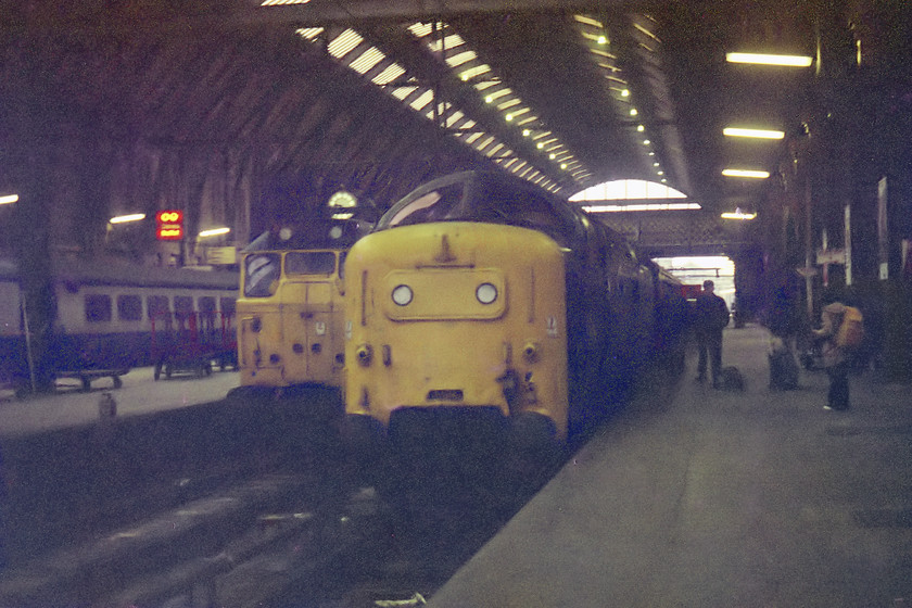 31408, station pilot working & 55004, unidentified up working, London Kings Cross Station 
 Our first Deltic of the day. I have this down in my notebook as 55004 'Queen's Own Highlander' sitting on the blocks at King's Cross on our arrival at about 09.00. However, the Chronicles of Napier website has this locomotive leading the 09.00 to Newcastle (1N08) at this time. So, unless it was rapidly able to be released from the stops, run round, attach and depart for Newcastle in a matter of minutes then something is wrong. It is probably my error but if anybody can help clear this inconsistency up I would be grateful. This picture clearly illustrates how dismal the interior of the King's Cross trainshed could be on a dull day before it was restored with years steam and diesel grime that was coating the glass cleaned off! Next to the Deltic is one of the station pilots, 31408 that brought a set of freshly serviced stock in from Finsbury Park. 
 Keywords: 31408 station pilot working 55004, unidentified up working London Kings Cross Station